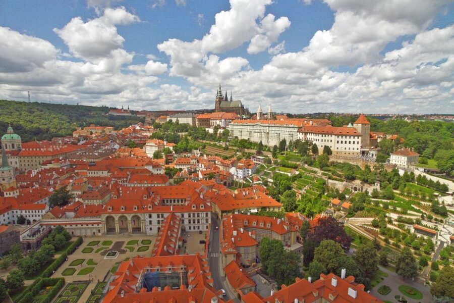 Prague old town rooftops and the castle above the Vltava at dusk